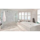 Kúpeľňa so spchovým kútom a vaňou s bielym obkladom a dlažbami