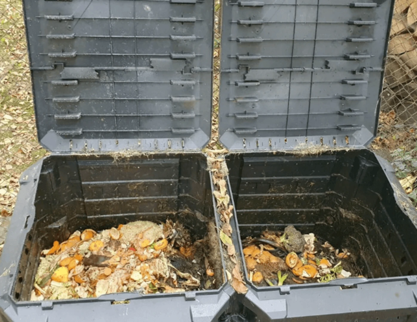 Rozkladajúci sa kompost vo veľkých záhradných nádobách.