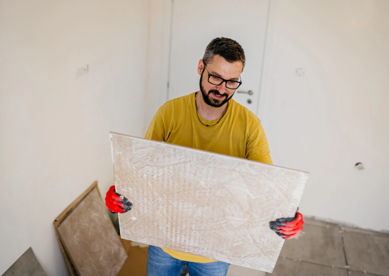 Človek držiaci veľkoformátovú dlažbu