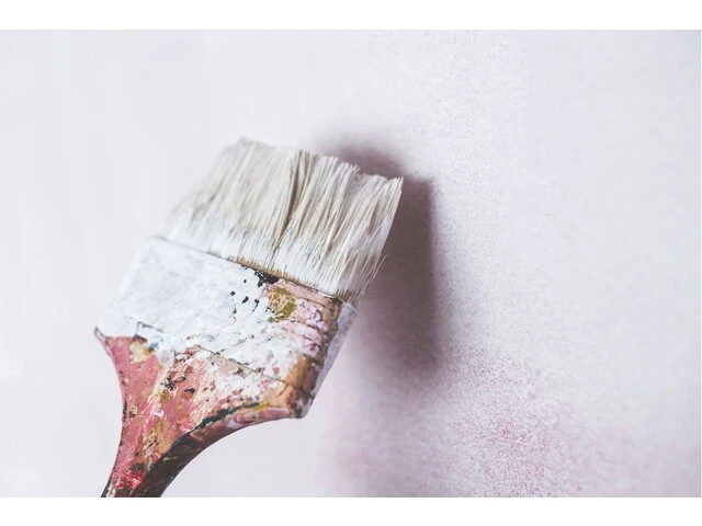 Nanášanie penetračného náteru na stenu štetcom.