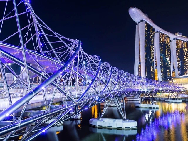Večerné osvetlenie mostu The Helix Bridge v Singapure
